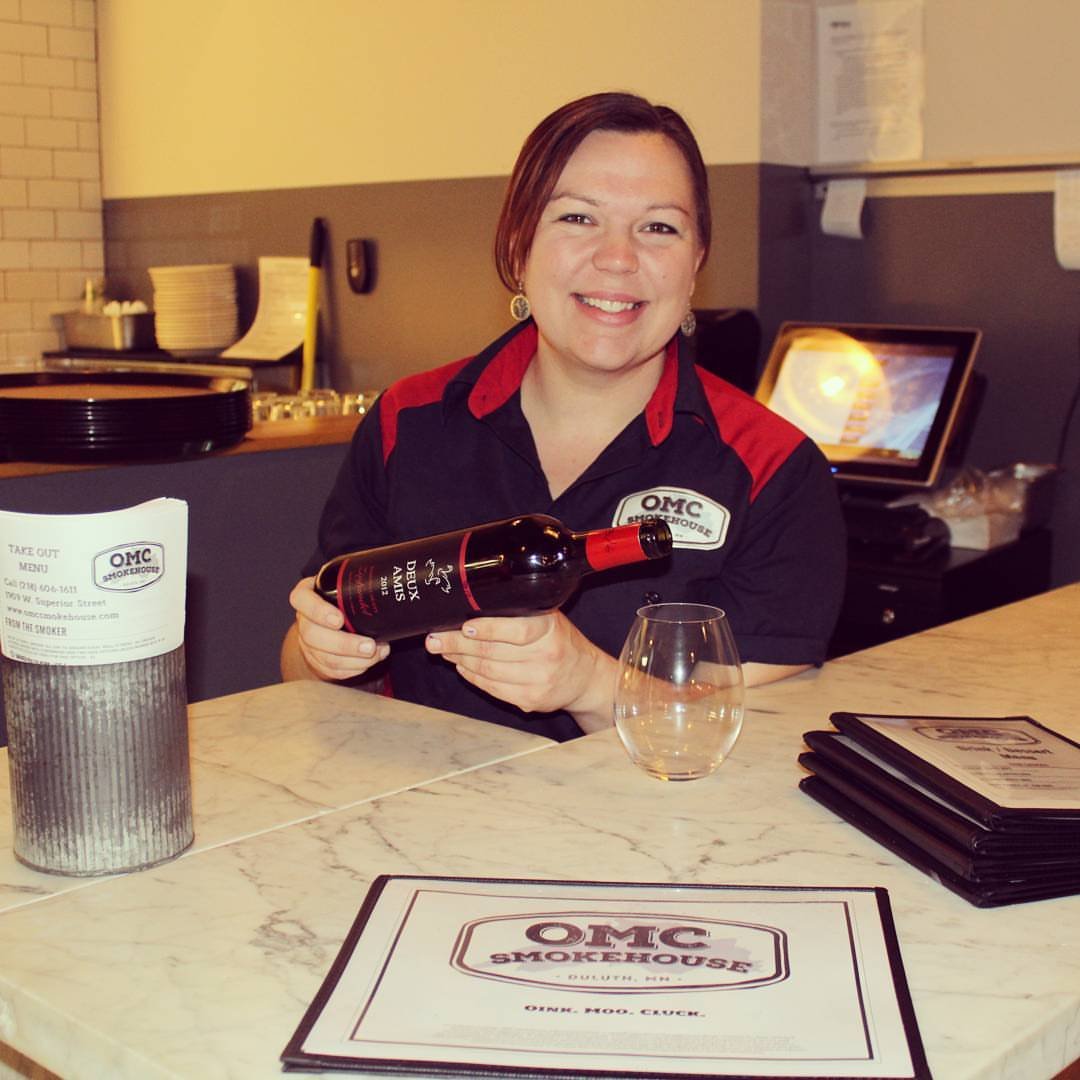 Happy Smokehouse Employee pouring wine